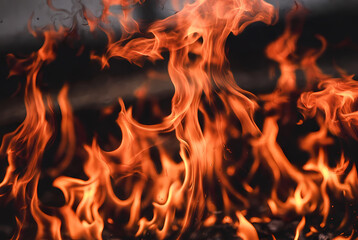 Fototapeta premium A close-up view of a large fire with bright orange flames burning