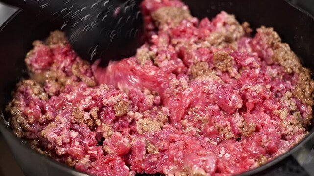 Juicy minced meat is simmering in the pan