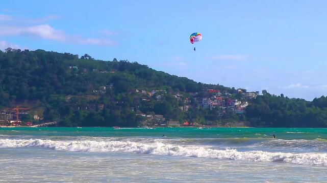 Tourism people on parasailing parachute sport activity Patong Phuket Thailand.
