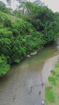 Aerial View of People Bathing In Tropical River