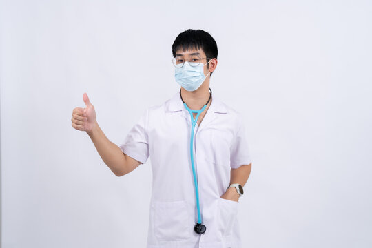 A young doctor wearing a face mask represents commitment to patient care, professional medical services, hospital standards, and compassionate healthcare delivery.