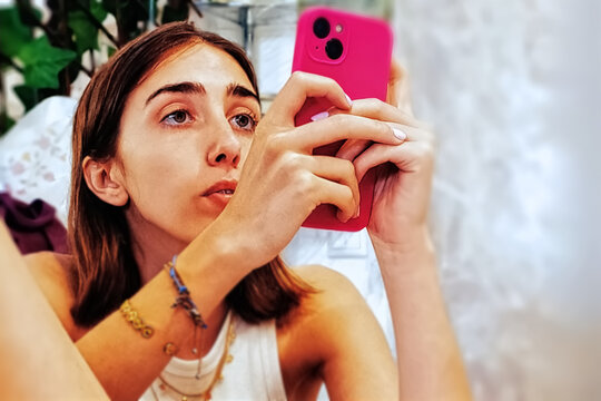 Young woman with mobile phone at home