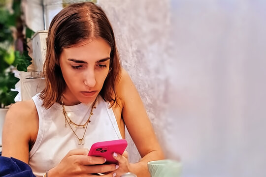Young woman with mobile phone at home