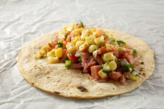 A view of a Spam taco, with corn salsa.