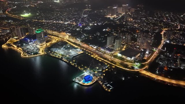 Ground Level Night City Lights Along Waterfront Highways