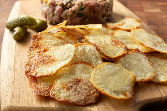 A view of a pile of homemade potato chips.