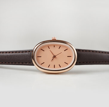 Elegant Rose Gold Oval watch with Brown Leather Strap isolated on White Background