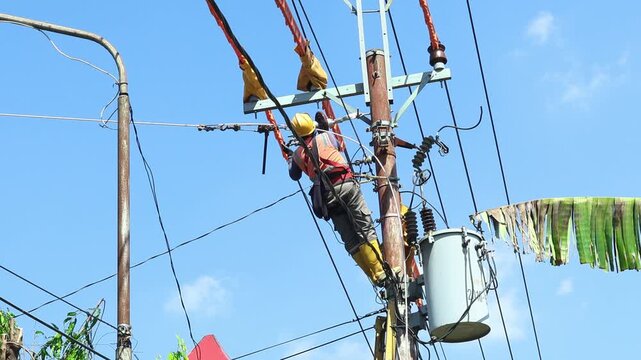 Electrical technicians with complete PPE are working on tightening the cable stretch under the 20 kV electrical voltage network.