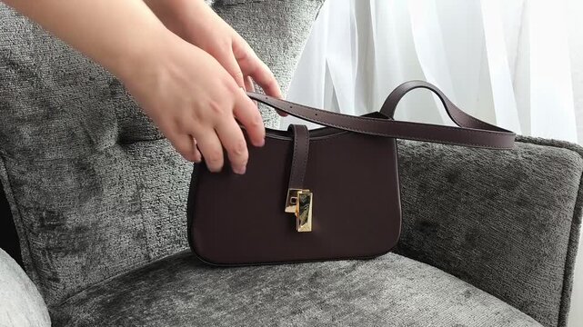 Woman shaking empty handbag, checking personal belongings, searching inside bag and everyday lifestyle concept.