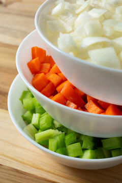 A view of a stack of bowls, featuring the mirepoix ingredients.