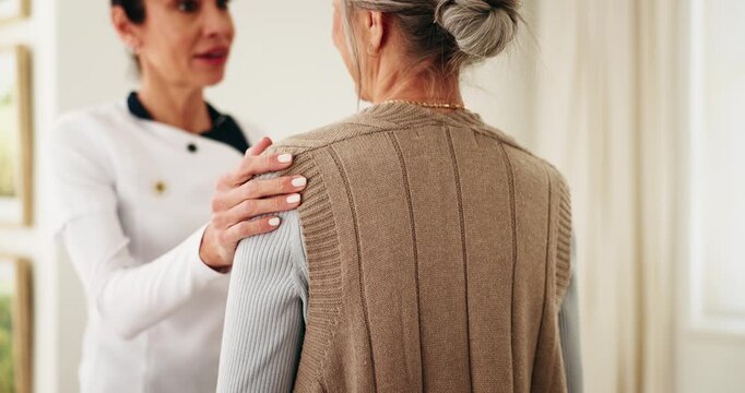 Talk, old woman and caregiver support in homecare with health checkup, follow up care and service. Hand on shoulder, senior patient and carer in assisted living, encourage healing and medical advice