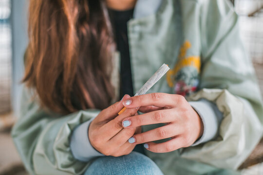 Woman's hands rolling a Marihuana joint, close-up