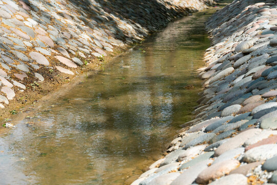 Stone-Lined Water Channel with Flowing Stream