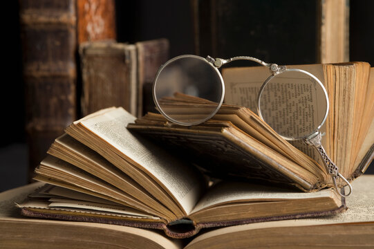 Lorgnette on stack of antique books