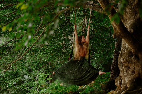 Swinging gracefully on a trapeze in a dreamy green forest