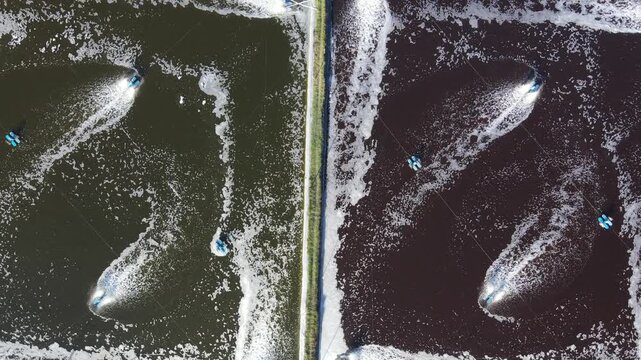 Aerial view of small boats creating wakes in the water at Pantai Pasir, separated by a narrow path in Kecamatan Ayah, Jawa Tengah, Indonesia.