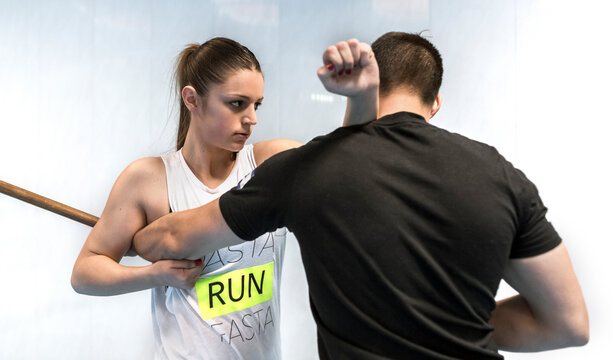 Young woman in gym doing self defense training