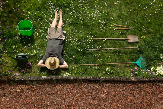 Man lying in grass relaxing from gardening