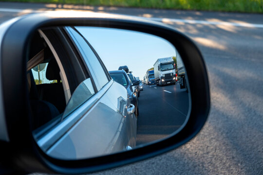 Wing mirror, rescue lane, cars and trucks during traffic jam in the evening, Germany