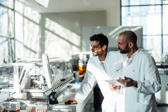 Scientists work on modern machine in laboratory