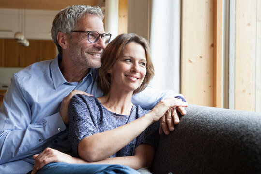 Smiling mature couple on couch