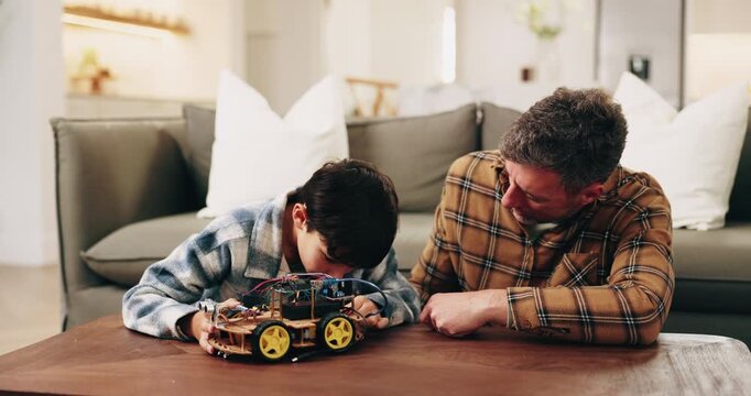 Dad, child and building with toy car in home for assembling parts, bonding or fun activity together. Father, kid or helping son on electrical motor vehicle for junior engineering or learning in house