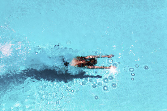 Woman diving underwater in swimming pool