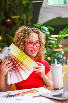 Smiling architect presenting color swatch on a video call