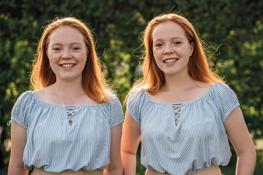 Smiling redheaded twins