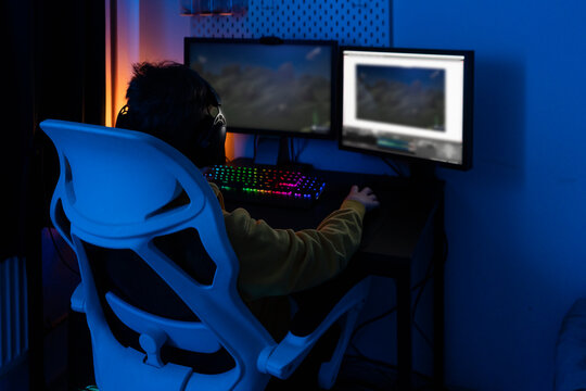 Boy playing video game at home