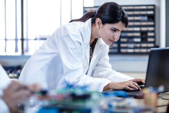 Woman in workshop using laptop