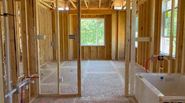 Trucking shot to the left revealing a custom master bathroom of a new home and highlighting high-quality craftsmanship. Perfect for subcontractor inspection and property development projects.