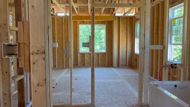 Trucking shot to the right revealing a custom master bathroom of a new home and highlighting high-quality craftsmanship. Perfect for subcontractor inspection and property development projects.