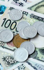 Japanese yen money bills and coins on table. Japan cash of JPY currency close up © Larysa