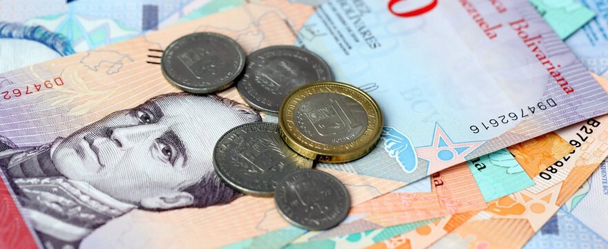 Venezuelan bolivar money bills and coins on table. Venezuela cash of VES currency close up