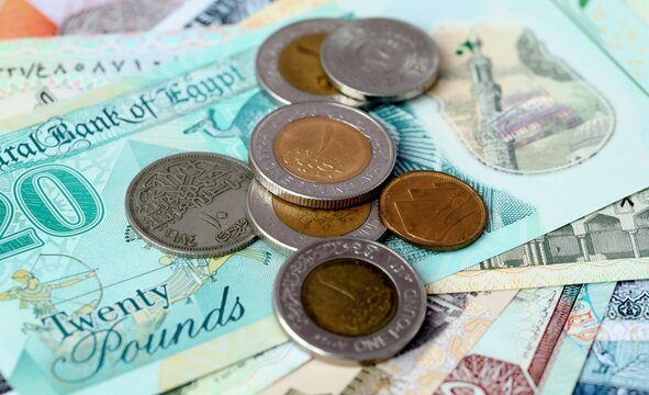 Egyptian pound money bills and coins on table. Egypt cash of EGP currency close up
