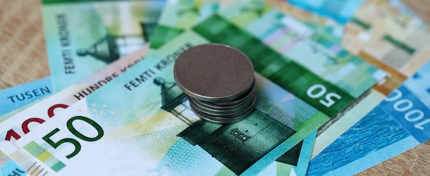 Norwegian krone money bills and coins on table. Norway cash of NOK currency close up