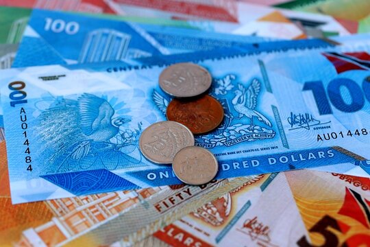 Trinidad and Tobago dollar money bills and coins on table. Trinidad and Tobago cash of TTD currency