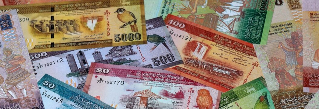 Sri Lankan rupee money banknotes bunch on table. Sri Lanka bills of LKR currency close up