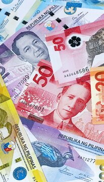 Philippine peso money banknotes bunch on table. Philippines bills of PHP currency close up