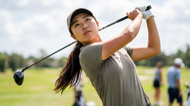 female asian golfer swing course sport athlete golf portrait drive athletic player finishing a drive shows movement balance and ambition for inclusive golf campaigns equipment ads and modern