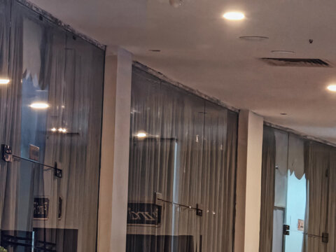 Modern Interior Lobby with Glass Panels, Curtains and Ceiling Lighting Reflections
