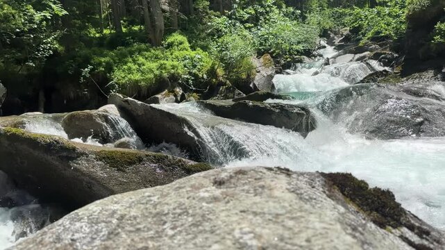 Fresh Water River Cascading Through Rocky Terrain in the Sunny Austrian Alps, Koenigsleiten in slow motion