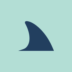 Fototapeta premium A dark blue shark fin silhouette on a light green background