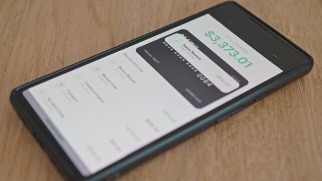 The concept of controlling expenses and income using online banking. Close-up of a smartphone displaying a mobile banking application with recent financial transactions