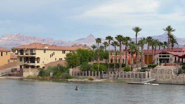 Laughlin, Nevada USA. Kayaker in Colorado River by Riverside Buildings on Sunny Day