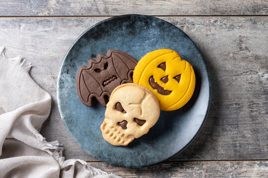 Halloween sandwich cookies with chocolate on wooden table. Top view
