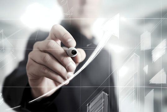 A businessman drawing a growing graph with a marker on a transparent screen
