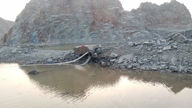 the river in the mountains, Huge Mound of Crushed Gray Stones in a Quarry