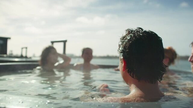 Friends relaxing in an outdoor hot tub at a spa retreat on a sunny day